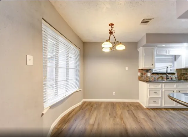 a view of kitchen with granite countertop cabinets and outdoor space