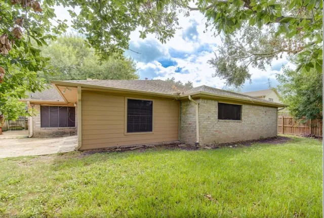 a front view of house with yard and trees