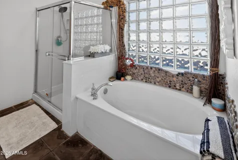 a bathroom with a bathtub and shower