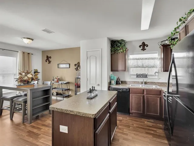 a kitchen with a stove sink and cabinets