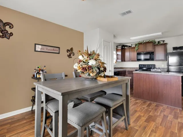 a view of a workspace room with wooden floor and furniture