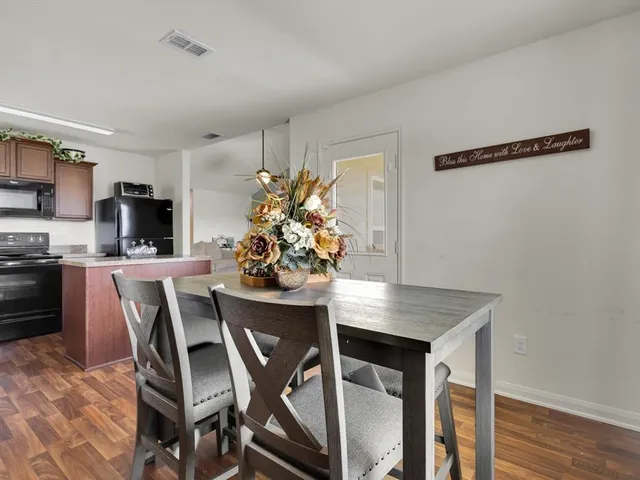 a view of a dining room with furniture and wooden floor