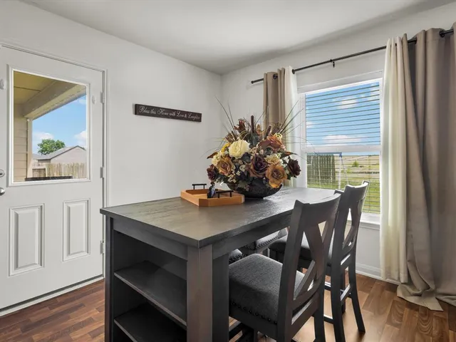a view of a dining room with furniture and wooden floor
