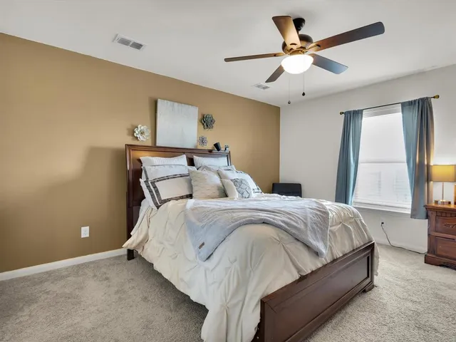 a bedroom with a bed and couch