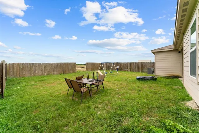 a view of a backyard with plants and outdoor seating