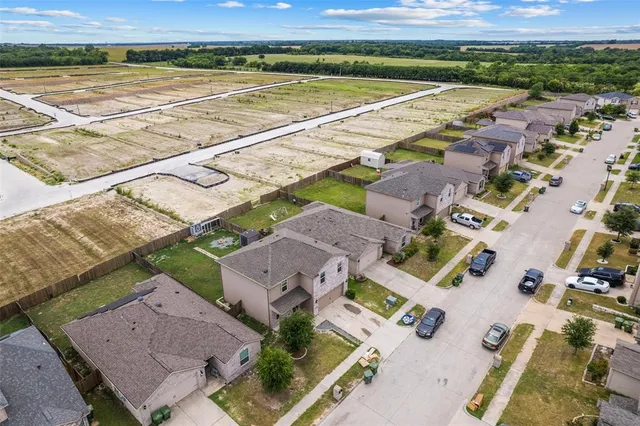 an aerial view of residential houses with outdoor space