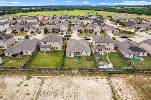an aerial view of residential houses with outdoor space