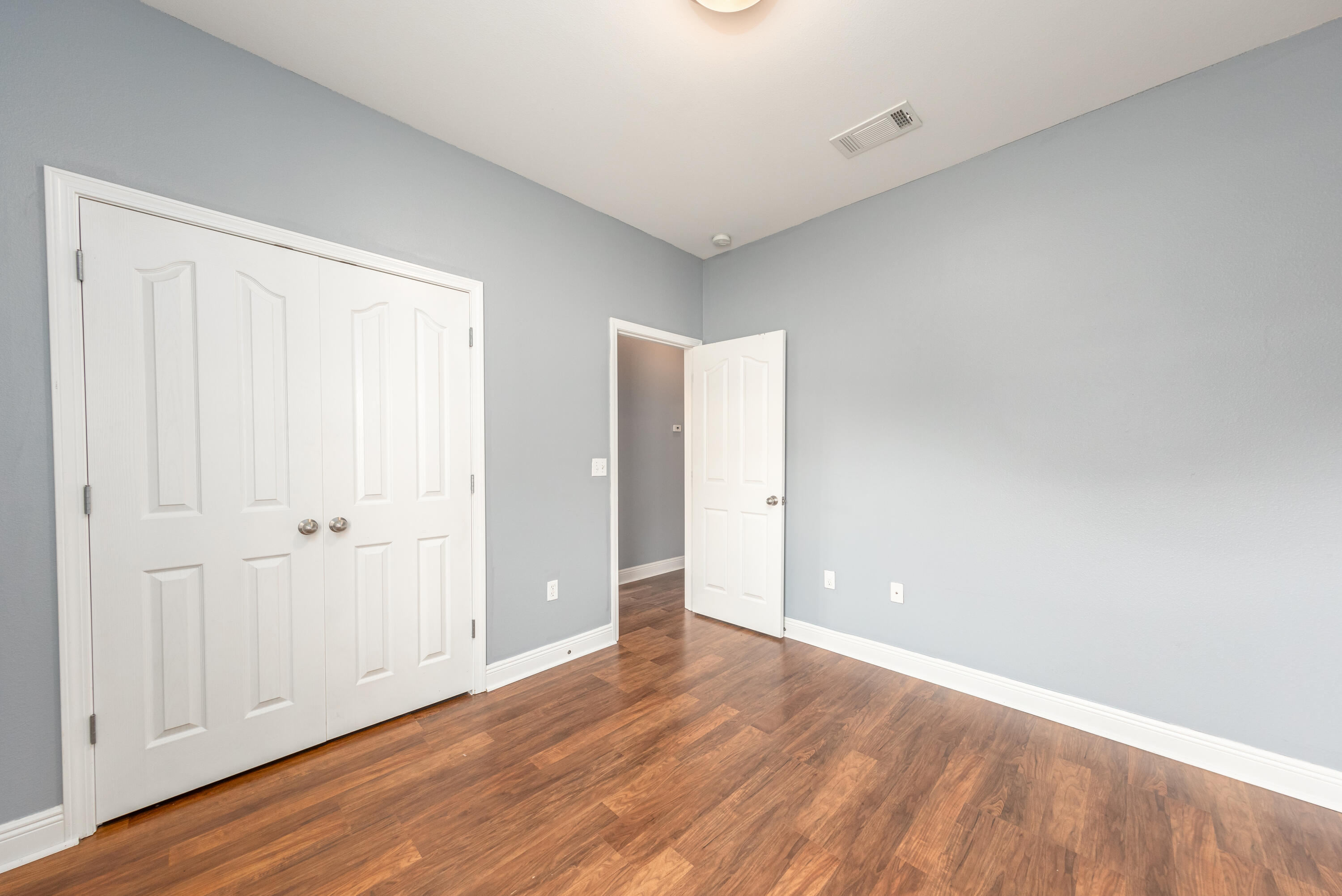 606 Rowan Circle Crestview, FL 32536 - Photo 11 of 24 a view of an empty room with wooden floor