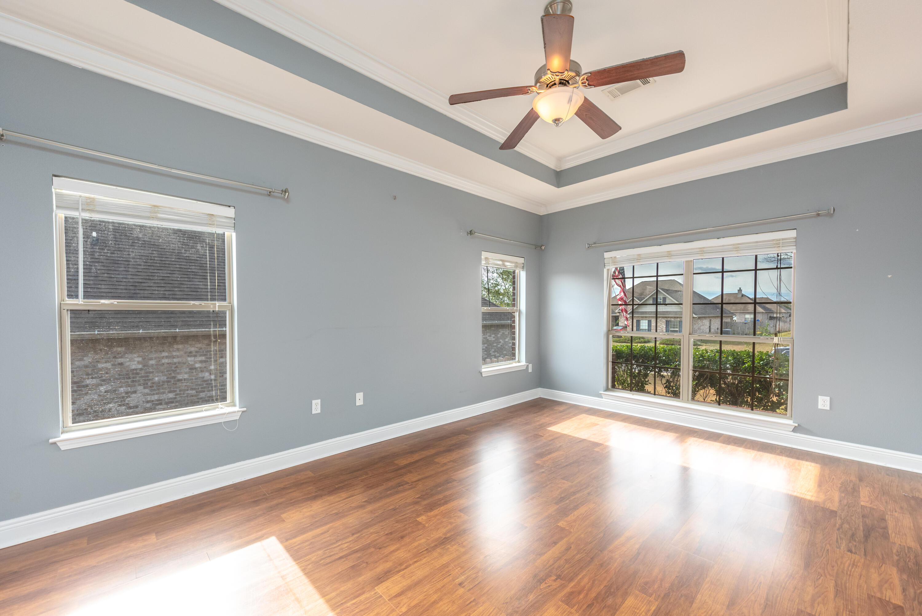 606 Rowan Circle Crestview, FL 32536 - Photo 16 of 24 a view of an empty room with a window and wooden floor
