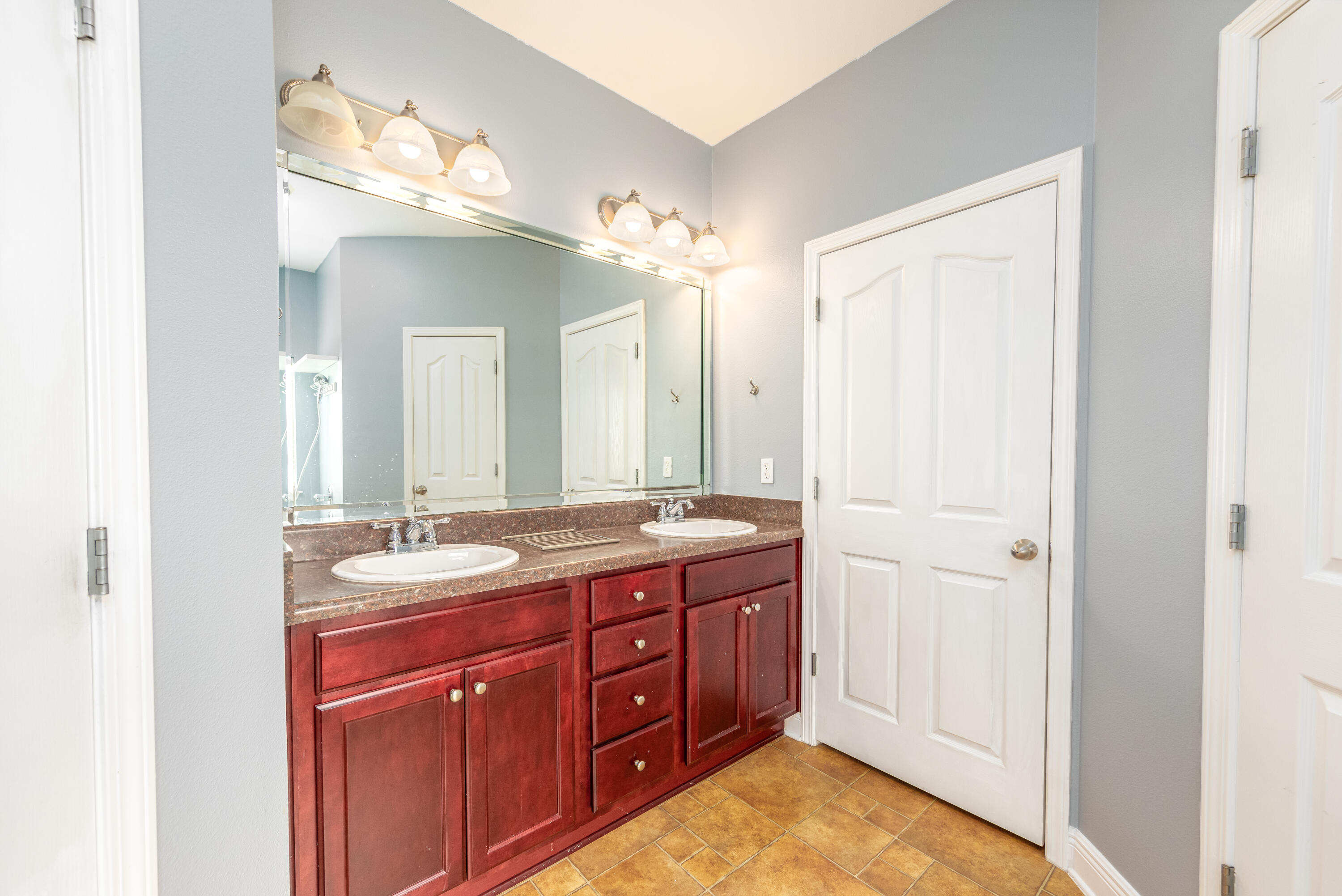 606 Rowan Circle Crestview, FL 32536 - Photo 18 of 24 a spacious bathroom with a granite countertop sink a mirror and a
