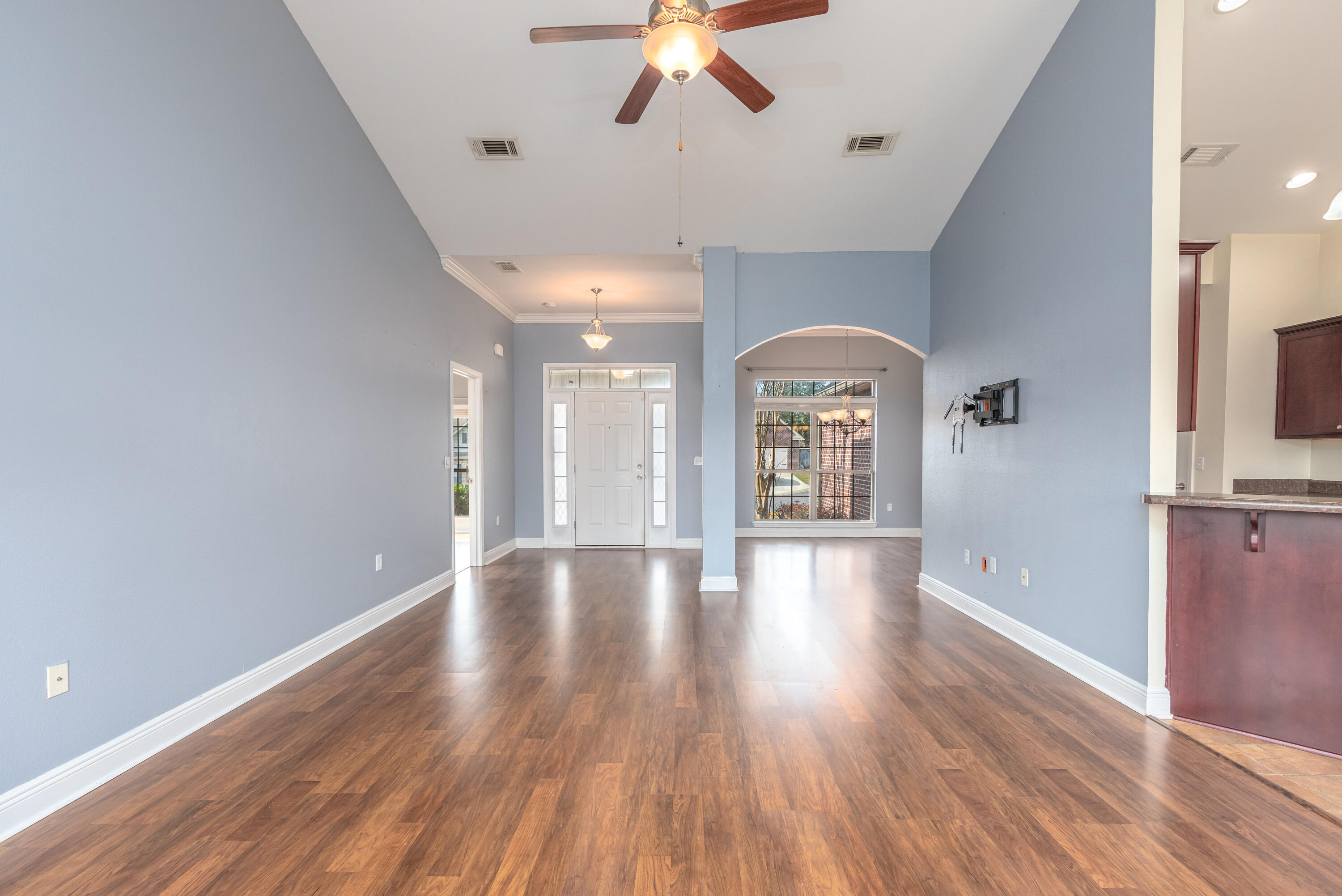 606 Rowan Circle Crestview, FL 32536 - Photo 4 of 24 a view of empty room with wooden floor and fan