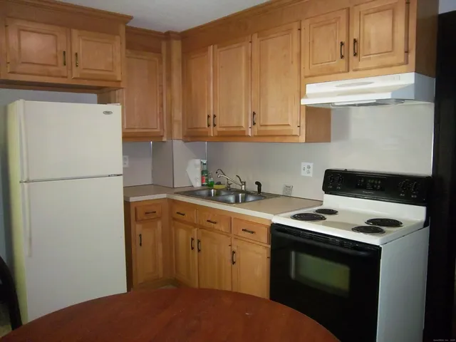 a kitchen with stainless steel appliances granite countertop a refrigerator stove a sink and dishwasher