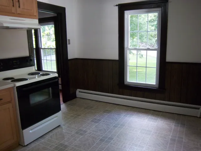 a kitchen with an oven and a window