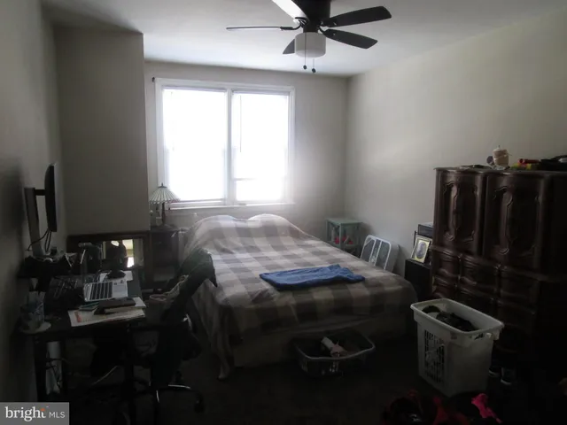a bed sitting in a room next to a window