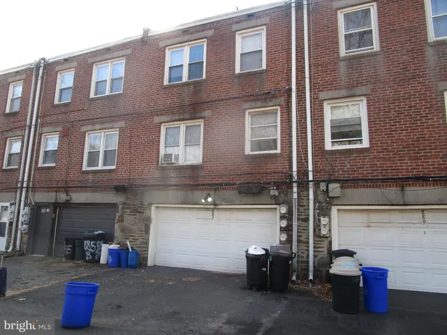 a view of a brick building with potted plants
