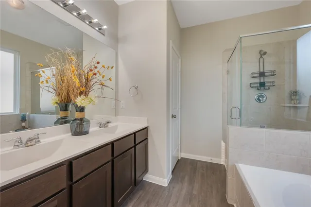 a bathroom with a tub and a shower