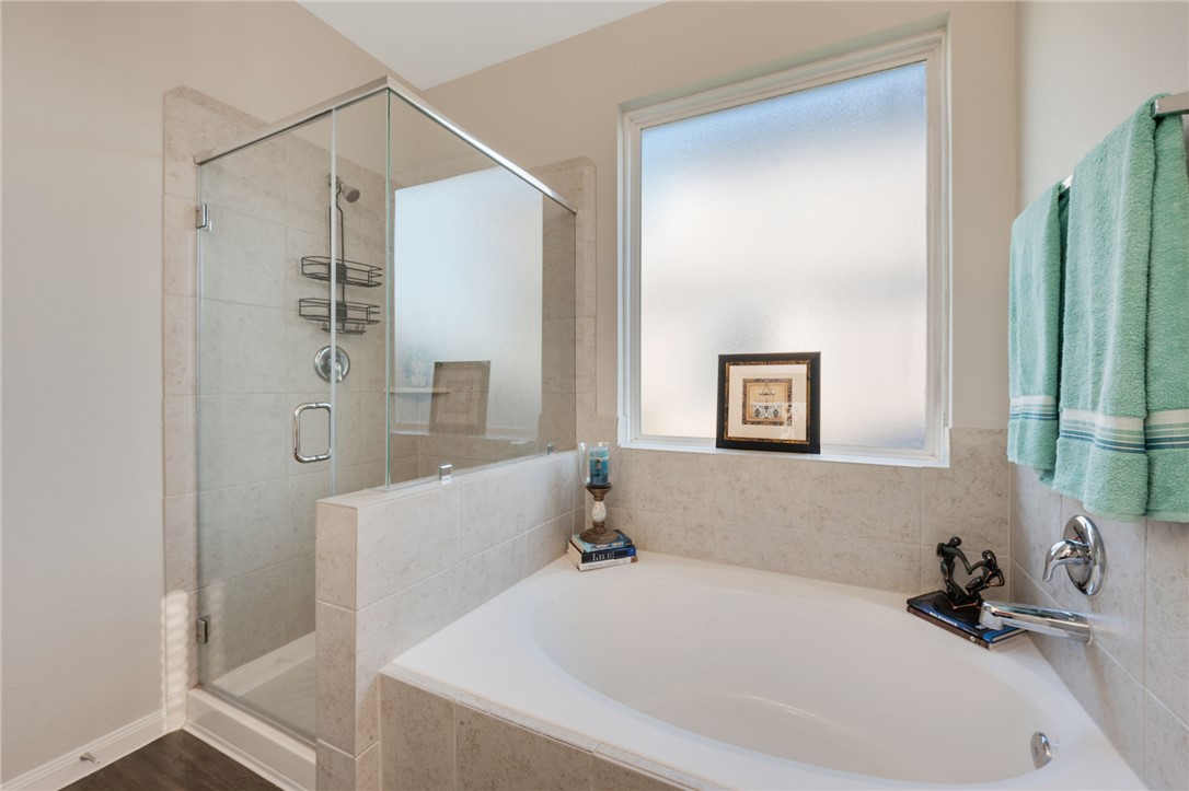 4704 Los Pines Way Bryan, TX 77807 - Photo 14 of 26 a bathroom with a tub and a shower