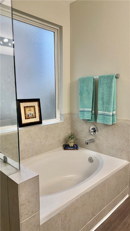 4704 Los Pines Way Bryan, TX 77807 - Photo 16 of 26 a bathroom with a bathtub and a sink