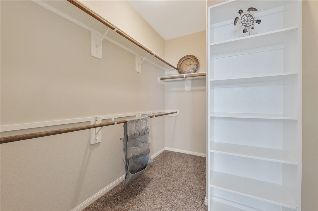 4704 Los Pines Way Bryan, TX 77807 - Photo 17 of 26 a view of walk in closet with empty racks