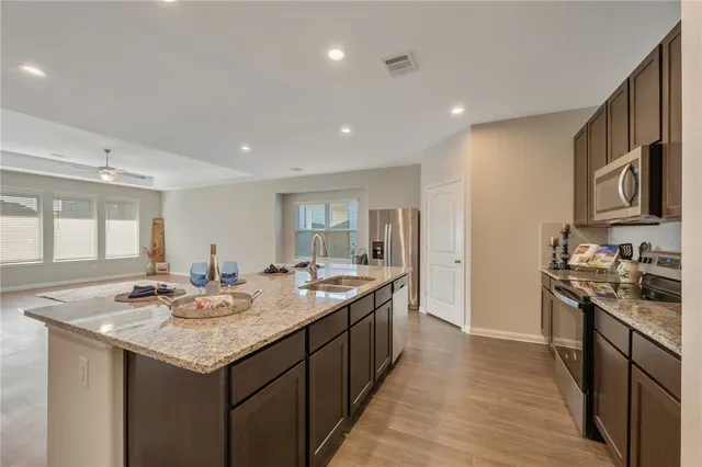 a kitchen with sink stove and refrigerator