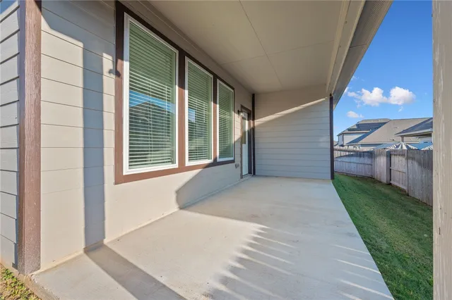 a view of a house with a backyard and a patio