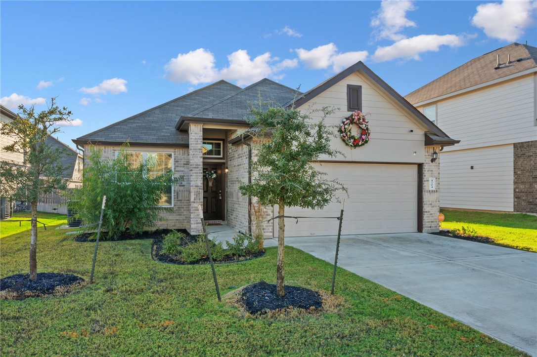 4704 Los Pines Way Bryan, TX 77807 - Photo 25 of 26 a view of a house with a backyard and a patio