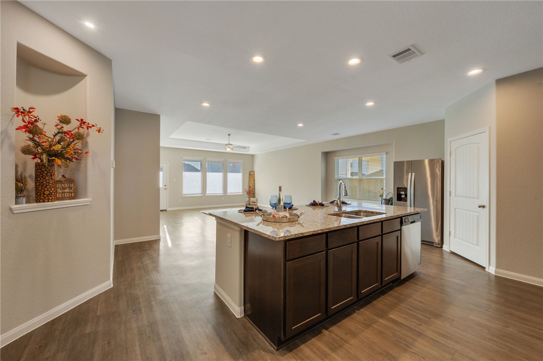 4704 Los Pines Way Bryan, TX 77807 - Photo 4 of 26 a kitchen with a sink and wooden floor