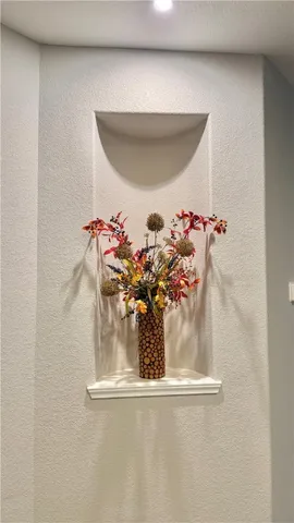 a kitchen with a refrigerator a stove top oven and wooden floor