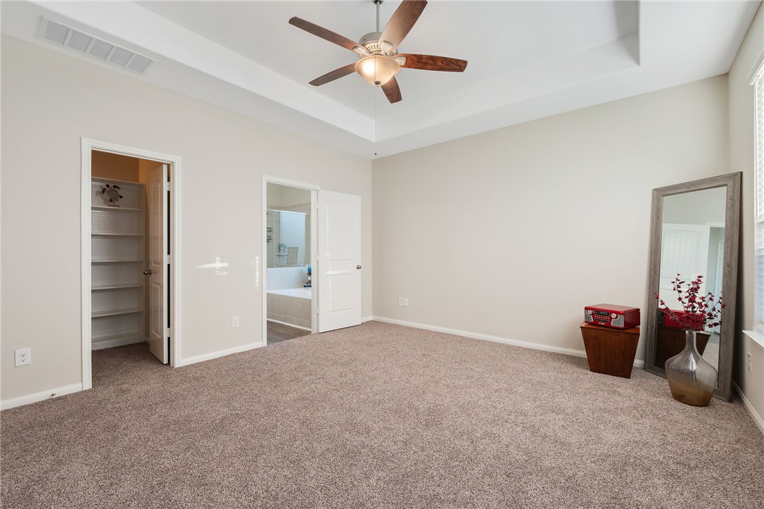 4704 Los Pines Way Bryan, TX 77807 - Photo 10 of 26 an empty room with closet and a ceiling fan