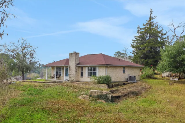 a front view of a house with a yard table and chairs