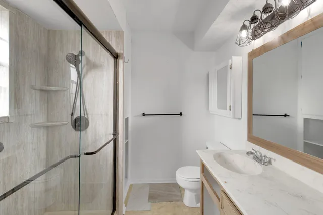 a bathroom with a sink toilet and shower
