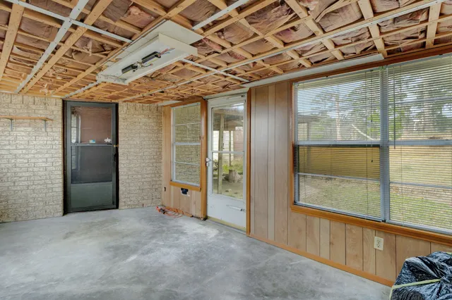 a view of a hallway with wooden floors