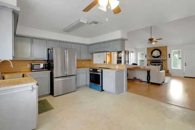 a kitchen with stainless steel appliances kitchen island a refrigerator and a stove