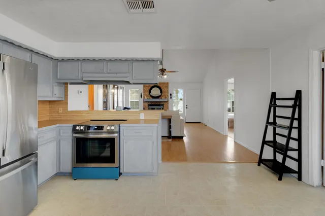 a kitchen with stainless steel appliances granite countertop a stove and a refrigerator