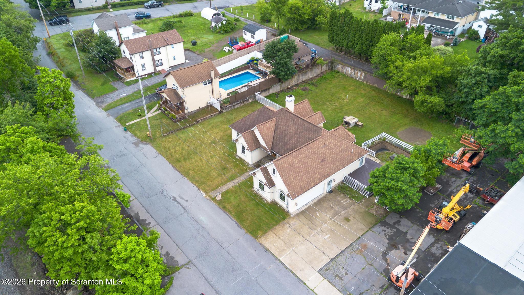 116 Forge Street Old Forge, PA 18518 - Photo 46 of 49 an aerial view of a house with a garden and lake view