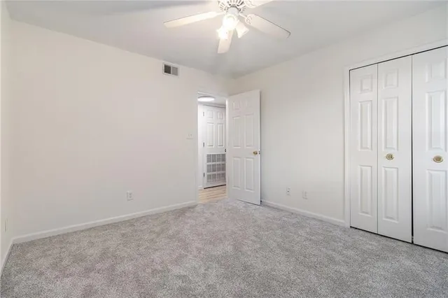an empty room with fan and entrance