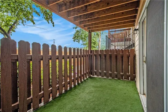 a view of a backyard with wooden fence