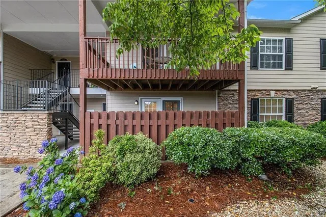 a view of a house with brick walls and potted plants