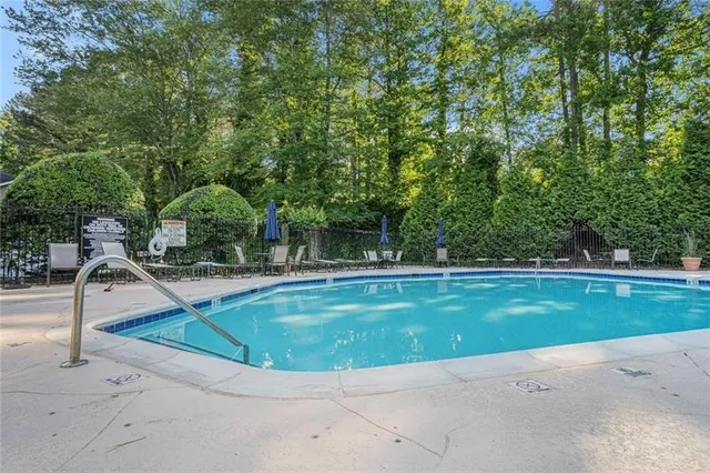 a view of a swimming pool with a yard
