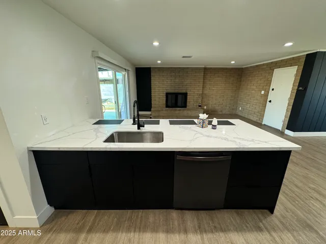 a sink with a large mirror and vanity