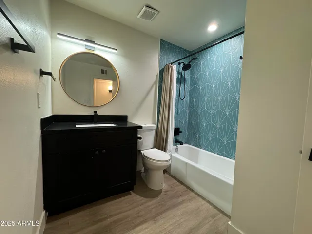 a bathroom with a toilet a sink and a mirror