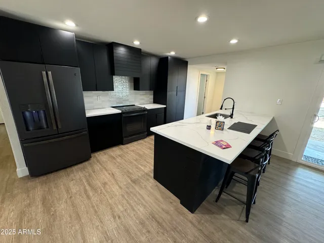 a kitchen with a sink cabinets and stainless steel appliances