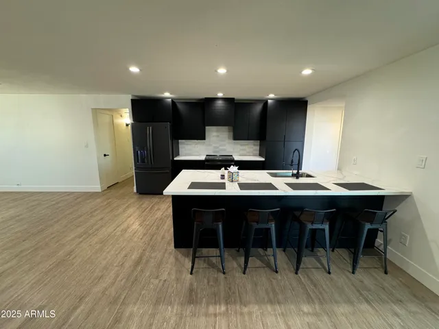 a large kitchen with a table and chairs