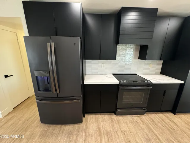 a kitchen with stainless steel appliances wooden floor sink and stove