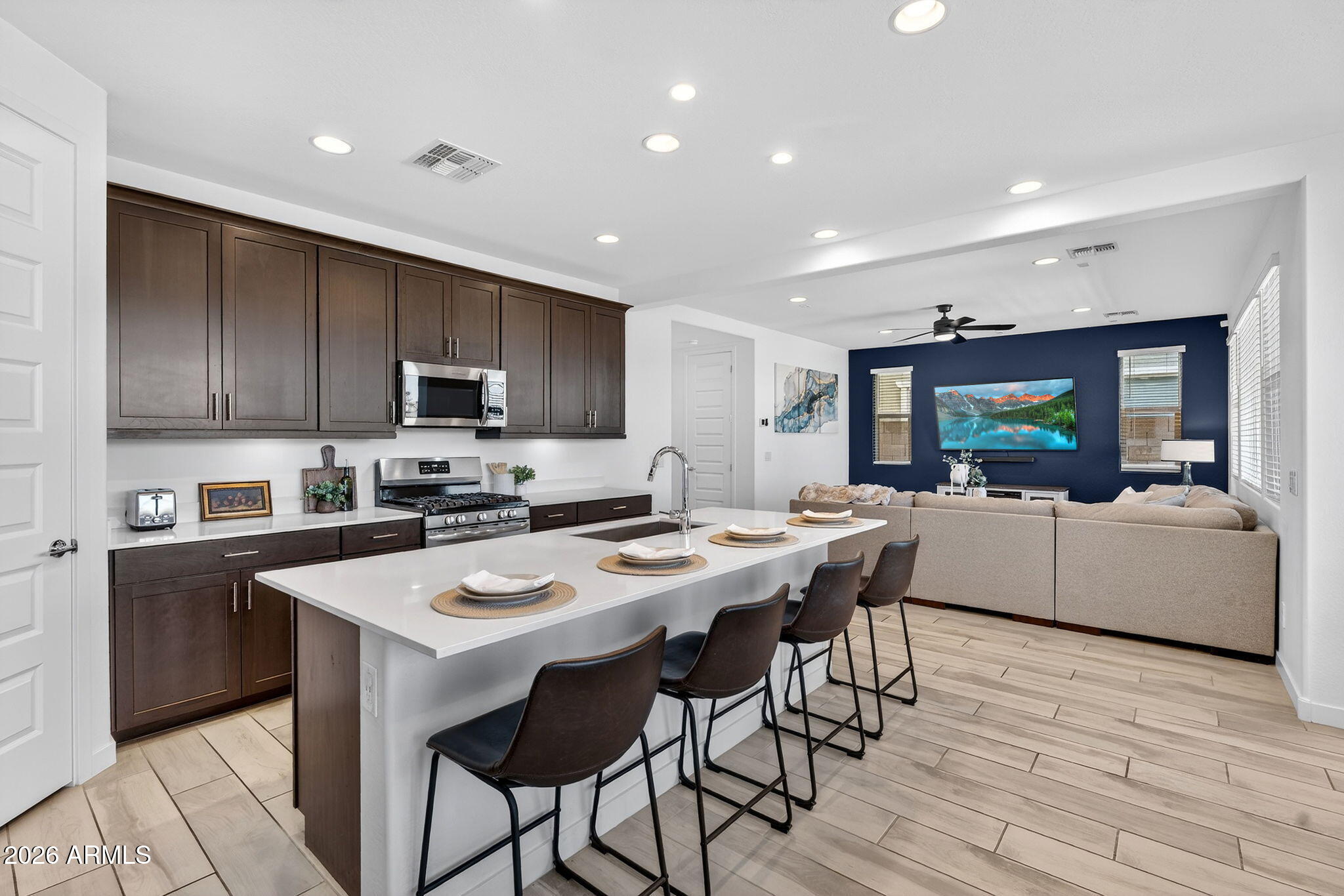 4112 East Appaloosa Road Gilbert, AZ 85296 - Photo 13 of 66 a kitchen with a table chairs refrigerator and microwave