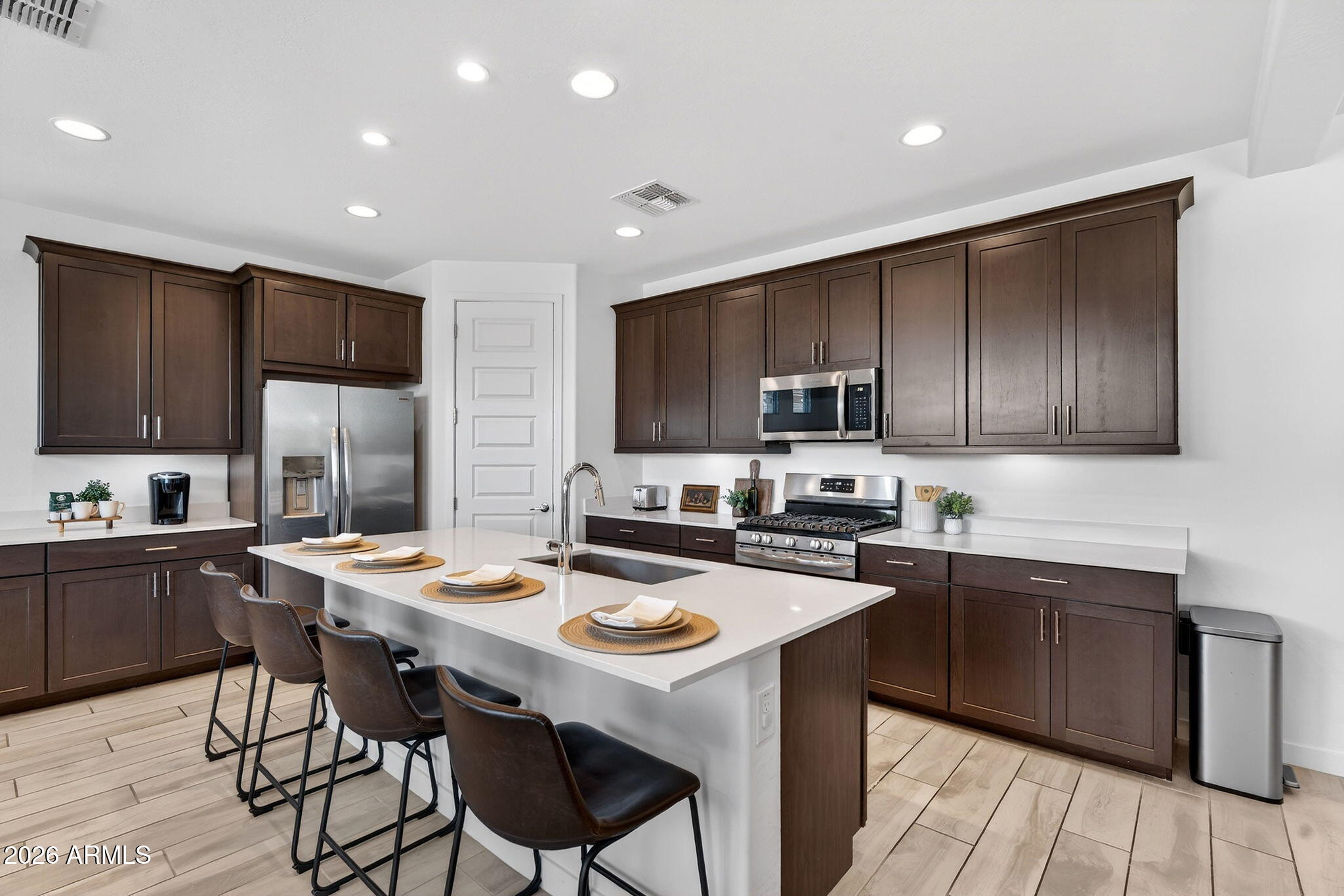 4112 East Appaloosa Road Gilbert, AZ 85296 - Photo 14 of 66 a kitchen with stainless steel appliances granite countertop wooden cabinets a refrigerator sink and stove