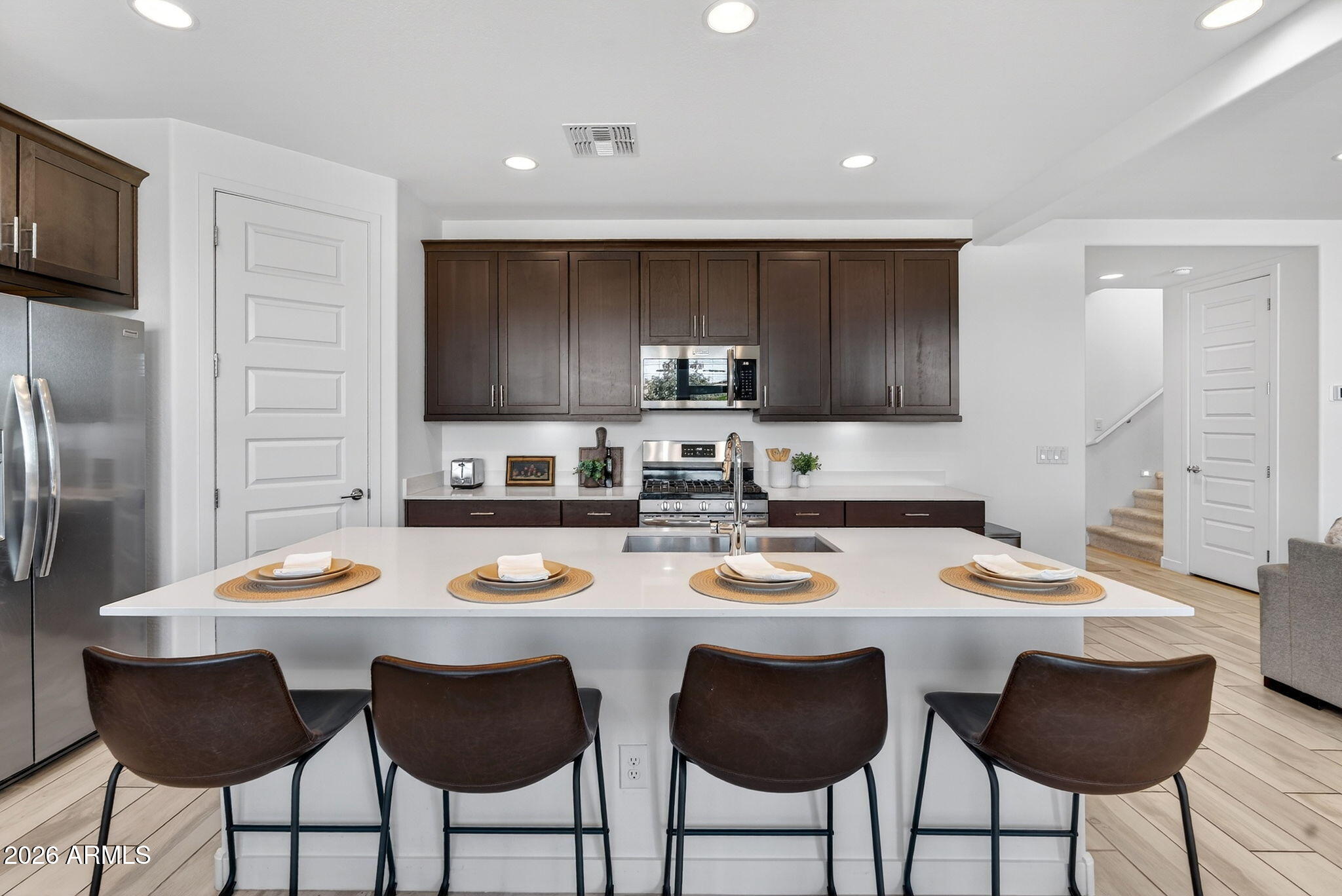 4112 East Appaloosa Road Gilbert, AZ 85296 - Photo 15 of 66 a kitchen with a dining table and chairs