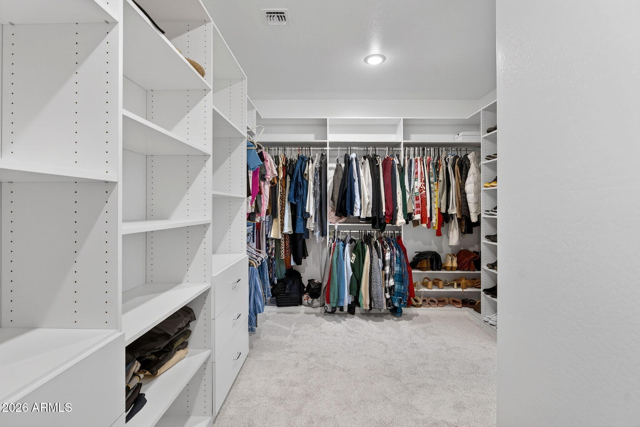 4112 East Appaloosa Road Gilbert, AZ 85296 - Photo 35 of 66 a view of walk in closet with clothes