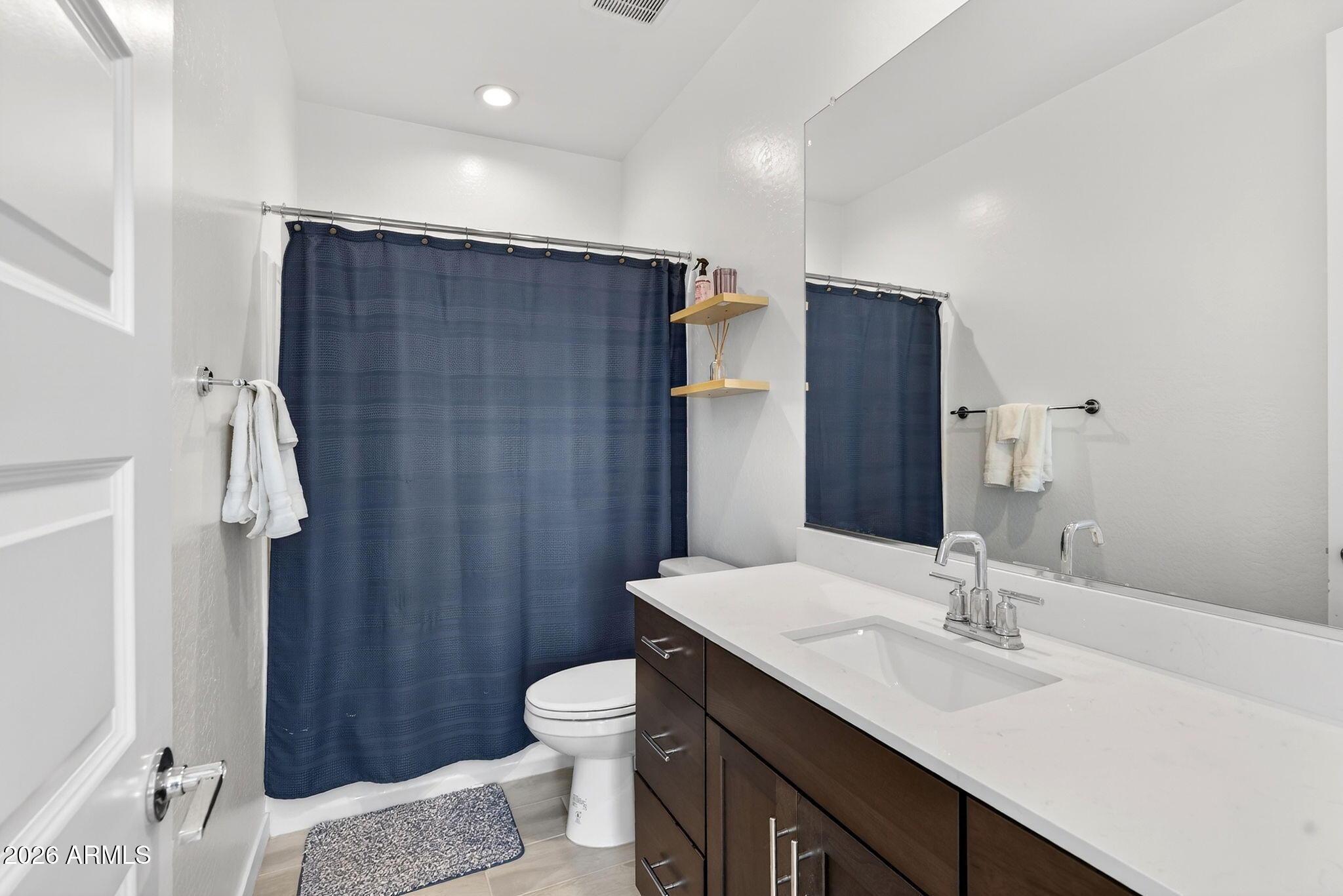 4112 East Appaloosa Road Gilbert, AZ 85296 - Photo 42 of 66 a bathroom with a sink toilet double vanity and shower