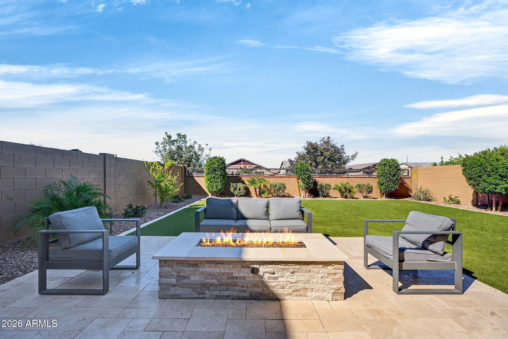 4112 East Appaloosa Road Gilbert, AZ 85296 - Photo 49 of 66 a view of a backyard with couches plants and large trees